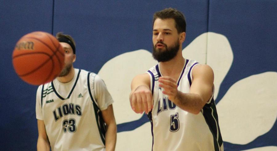 Shawn Hill passes the ball as Mike Lucier (33) looks on